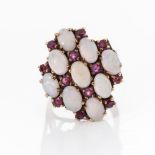 AN OPAL AND RUBY RING Designed as a honeycomb claw set with nine oval natural opal and twelve