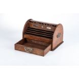 A MAHOGANY STATIONERY BOX The curved rolling lid with graduating stationary compartments and