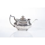 A GEORGE III SILVER TEA POT, SOLOMON HOUGHAM, LONDON, 1815 Gadrooned rim, hinged gadrooned cover