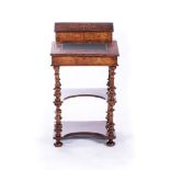 A VICTORIAN WALNUT CANTERBURY ETAGERE The serpentine top surmounted with urn finials, four carved,