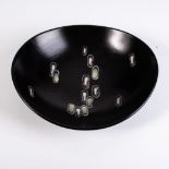A DUTCH GOUDA 'ECLIPSE' PATTERN DISH, 20TH CENTURY With scattered lozenges of colour on a dark