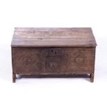 AN OAK CHEST, 18TH CENTURY The hinged rectangular top enclosing a compartment, carved front panel,