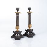 A PAIR OF BRONZE AND GILT-METAL CANDLESTICKS Each fluted column supported on three paw feet raised