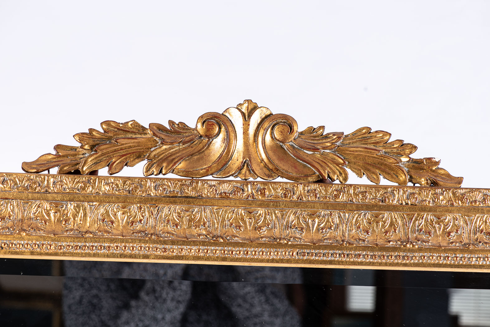 A GILTWOOD MIRROR The rectangular plate within a conforming beaded and moulded frame, surmounted - Bild 2 aus 2