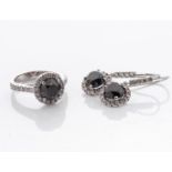 A PAIR OF DIAMOND EARRINGS AND MATCHING RING Claw-set to the centre with three round brilliant-cut