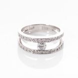 A GOLD AND DIAMOND RING Tension-set to the centre with a round brilliant-cut diamond weighing 0,