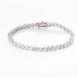 A DIAMOND TENNIS BRACELET Claw-set with 59 round brilliant-cut diamonds with a combined weight of