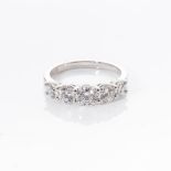 A DIAMOND ETERNITY RING claw set with five round brilliant cut diamonds with a combined weight of