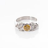 A DIAMOND RING Bezel set to the centre with a vivid yellow round diamond weighing 0.64ct clarity SI1