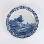 A DUTCH DELFT CHARGER, 20TH CENTURY Depicting a pastoral scene with a river flowing through fields