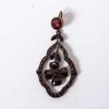 A GARNET PENDANT Set to the centre with four heart shaped garnets in a four leaf clover design