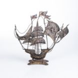 A PAINTED SILVER MODEL OF A PORTUGUESE CARAVEL The vessel, sails and flags in filigree31cm high,