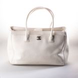 A CHANEL IVORY EXECUTIVE TOTE Dual exterior pockets, front with CC lock, 2 interior zip pockets,