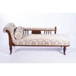 A VICTORIAN MAHOGANY CHAISE LONGUE The padded seat surmounted by a scroll button-back, the padded