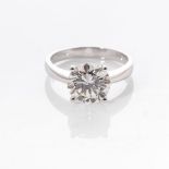 A PLATINUM SOLITAIRE RING Claw-set to the centre with a round brilliant-cut diamond weighing 3,