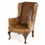 A LEATHER UPHOLSTERED WINGBACK ARMCHAIR, 19TH CENTURY