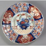 A JAPANESE IMARI 'FLOWER BASKET' PLATE, MEIJI PERIOD, 1868 - 1912