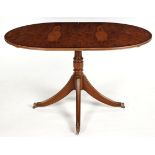 A REGENCY STYLE WALNUT AND MAHOGANY EXTENDING DINING TABLE