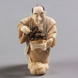 A JAPANESE IVORY NETSUKE OF A BONSAI KEEPER,SHŌWA PERIOD, 1926 - 1989