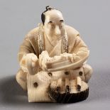 A JAPANESE IVORY NETSUKE OF A SCULPTOR, SHŌWA PERIOD, 1926 - 1989