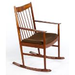 A TEAK ROCKING CHAIR DESIGNED BY ARNE VODDER