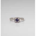 9CT WHITE GOLD OVAL TANZANITE AND DIAMON HALO RING