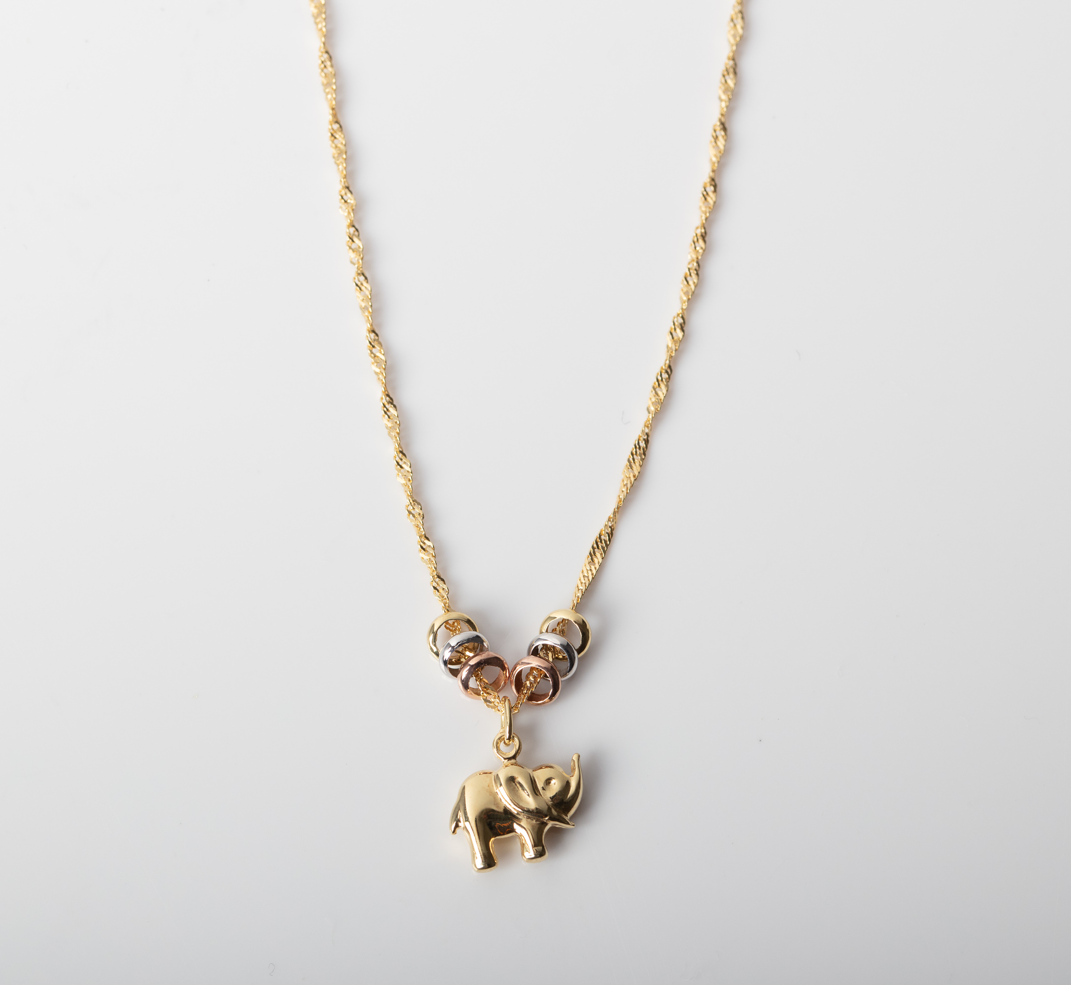 A 14CT AND SILVER BONDED ELEPHANT AND LUCKY RINGS NECKLACE