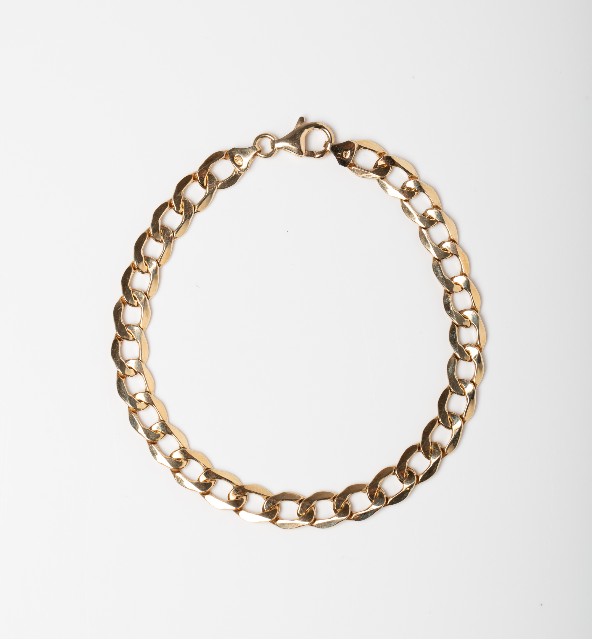 A 9CT GOLD & SILVER CURB BONDED BRACELET