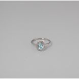 9CT WHITE GOLD BLUE TOPAZ AND DIAMOND OVAL HALO RING