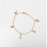 A 9CT GOLD & SILVER BONDED CHARM BRACELET