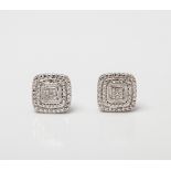 A PAIR OF DIAMOND CUSHION SHAPED STUD EARRINGS