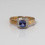 9CT YELLOW GOLD CUSHION TANZANITE AND DIAMOND HALO RING