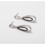 A PAIR OF SILVER BLACK AND WHITE DIAMOND DROP EARRINGS