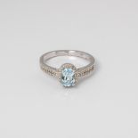 9CT WHITE GOLD BLUE TOPAZ AND DIAMOND OVAL HALO RING