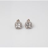 A PAIR OF 9CT GOLD AND SILVER CREATED WHITE SAPPHIRE AND DIAMOND VINTAGE STUD EARRINGS