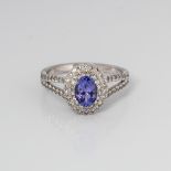 9CT WHITE GOLD OVAL TANZANITE AND DIAMOND DOUBLE HALO RING