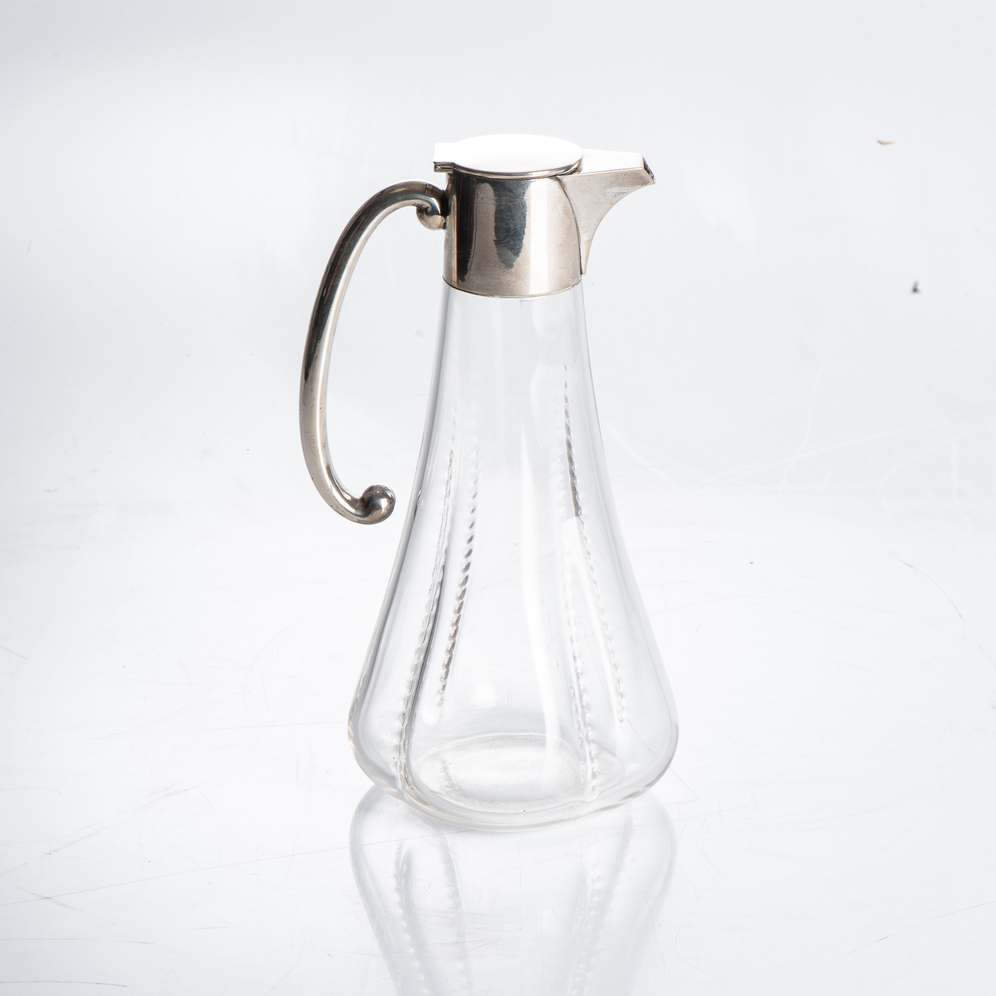 A SILVER-MOUNTED GLASS CLARET JUG