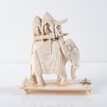 AN INDIAN IVORY CARVING OF A CAPARISONED ELEPHANT