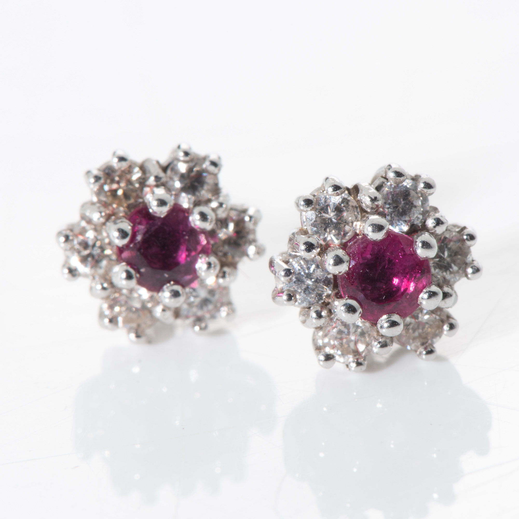 A PAIR OF RUBY AND DIAMOND STUDS