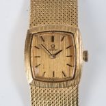 A LADY'S 18CT GOLD OMEGA WATCH