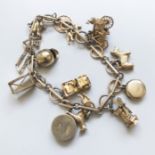 A 9CT GOLD CHARM BRACELET