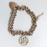 A 9CT GOLD CHARM BRACELET