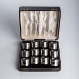 A BOXED SET OF TWELVE SILVER NAPKIN RINGS