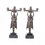 A PAIR OF BRONZE FIGURAL CANDLEHOLDERS