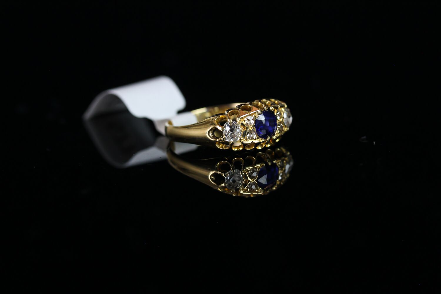 George V, Sapphire and Diamond carved half hoop ring, central 4.4mm blue sapphire, with old cut - Image 2 of 3