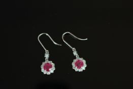 14ct White Gold Ruby and Diamond earrings featuring, 2 round cut, red Rubies (2.19ct TSW), claw set,
