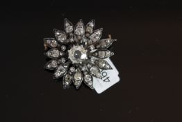 18CT DIAMOND SET STAR BURST BROOCH, centre stone estimated as 1.20ct, mounted with old and rose