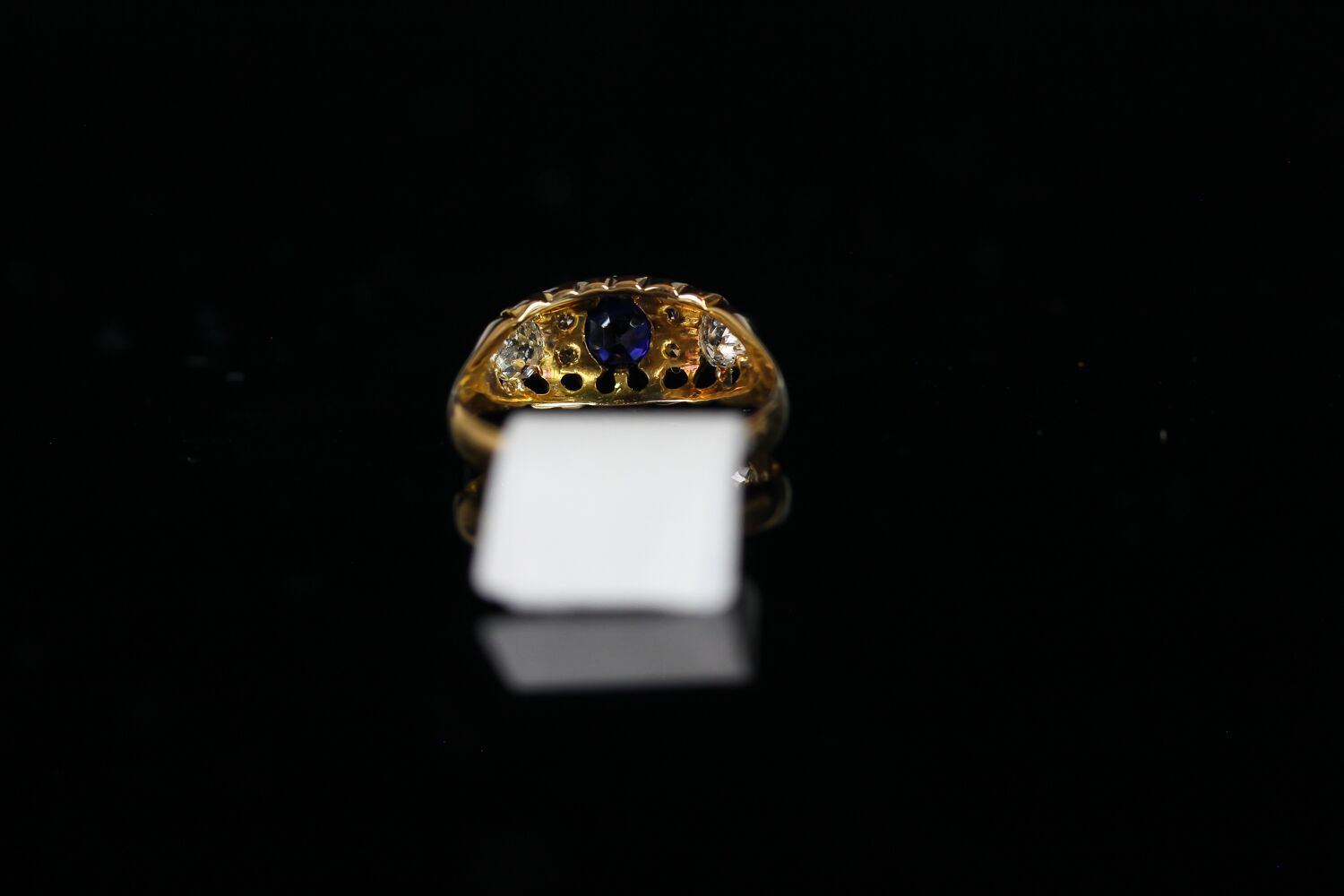 George V, Sapphire and Diamond carved half hoop ring, central 4.4mm blue sapphire, with old cut - Image 3 of 3