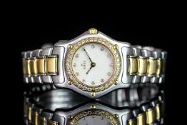 LADIES' EBEL BI COLOUR DIAMOND BEZEL WRISTWATCH, circular mother of pearl diamond dot dial with gold