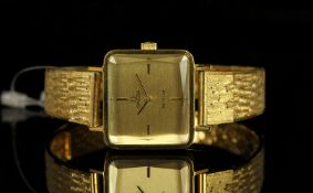 LADIES OMEGA DE VILLE GOLD PLATED WRISTWATCH, rectangular gold dial with black hour markers and